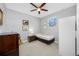 Bedroom with neutral carpet, ceiling fan, side table, and guitar at 2270 Spring Lake Ct, Clearwater, FL 33763