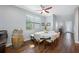 Cozy dining area with a round table, hardwood floors, and a rustic barrel accent, creating a warm and inviting space at 2270 Spring Lake Ct, Clearwater, FL 33763