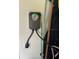 Close up view of a gray ChargePoint EV charger mounted to the wall inside a garage at 2270 Spring Lake Ct, Clearwater, FL 33763