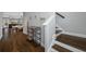 Warm entryway featuring wood floors, a staircase with wood treads, and an open view to the dining and living areas at 2270 Spring Lake Ct, Clearwater, FL 33763