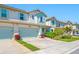 Charming townhome exterior with a blue garage door, tidy landscaping, and a well-maintained lawn at 2270 Spring Lake Ct, Clearwater, FL 33763