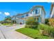 Charming townhome exterior with manicured lawns, beautiful landscaping, and attached garages on a bright, sunny day at 2270 Spring Lake Ct, Clearwater, FL 33763