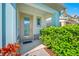 Inviting front door with glass accents, complemented by decorative plants and landscaping, set against a light-colored facade at 2270 Spring Lake Ct, Clearwater, FL 33763