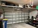 View of an organized garage with ceiling storage and a white paneled garage door at 2270 Spring Lake Ct, Clearwater, FL 33763