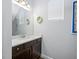 Stylish half bathroom with a decorative mirror, elegant countertop, and soft natural light at 2270 Spring Lake Ct, Clearwater, FL 33763