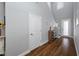 Bright hallway featuring hardwood floors, high ceilings, and a staircase that leads to the upper levels of the home at 2270 Spring Lake Ct, Clearwater, FL 33763