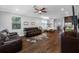 Living room featuring wood floors, a leather sofa, and an open floor plan at 2270 Spring Lake Ct, Clearwater, FL 33763