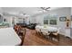 Open-concept living room featuring hardwood floors, fan, and two leather sofas with natural light from the windows at 2270 Spring Lake Ct, Clearwater, FL 33763