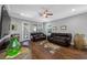 Cozy living room with comfortable leather sofas and wood-look tile flooring at 2270 Spring Lake Ct, Clearwater, FL 33763