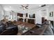 Spacious living room with leather couches, wood floors, and an open layout to the kitchen at 2270 Spring Lake Ct, Clearwater, FL 33763