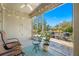 Relaxing screened patio showcases outdoor furniture, a view of the lake, and mature trees at 2270 Spring Lake Ct, Clearwater, FL 33763