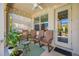 Inviting outdoor seating area with a ceiling fan, ambient string lights, and comfortable chairs at 2270 Spring Lake Ct, Clearwater, FL 33763
