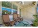 Cozy screened-in porch features comfortable rocking chairs, ambient lighting, and a green outdoor rug at 2270 Spring Lake Ct, Clearwater, FL 33763