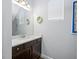 Bright powder room featuring modern fixtures, updated vanity, and unique wall decor at 2270 Spring Lake Ct, Clearwater, FL 33763