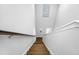 Stairway with wood steps and white walls leading to upstairs of home at 2270 Spring Lake Ct, Clearwater, FL 33763