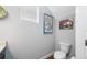 Cozy half-bath featuring stylish wall decor, a modern toilet, and ample natural light at 2270 Spring Lake Ct, Clearwater, FL 33763