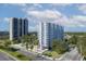 Aerial view of residential buildings, pool, landscaping, and palm trees on a clear day at 2401 Bayshore Blvd # Cu1, Tampa, FL 33629