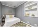Bedroom featuring a queen-size bed with a white comforter and leafy artwork on gray walls at 2401 Bayshore Blvd # Cu1, Tampa, FL 33629