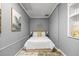 Bedroom featuring a queen-size bed with a white comforter and leafy artwork on gray walls at 2401 Bayshore Blvd # Cu1, Tampa, FL 33629