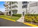 Building exterior showing manicured landscaping, a walkway, and architectural features at 2401 Bayshore Blvd # Cu1, Tampa, FL 33629