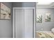Hallway with a white closet door and botanical artwork adorning gray walls at 2401 Bayshore Blvd # Cu1, Tampa, FL 33629