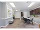 Bright living room featuring hardwood floors, gray walls, dark wood cabinets, and a dining table at 2401 Bayshore Blvd # Cu1, Tampa, FL 33629