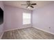 Bedroom featuring a ceiling fan and wood-look floors at 2489 Aster Dr, Palm Harbor, FL 34684