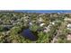 Stunning aerial view of the neighborhood showcasing lush landscaping, waterfront access, and picturesque ponds at 2633 N Dundee St, Tampa, FL 33629