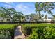 Waterfront backyard featuring a dock, lush greenery, and a serene view of the home's exterior at 2633 N Dundee St, Tampa, FL 33629