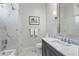 Modern bathroom featuring marble shower, vanity with marble countertop, and contemporary fixtures at 2633 N Dundee St, Tampa, FL 33629