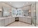 Bright bathroom featuring a double vanity, plentiful cabinet space, and walk-in shower at 2633 N Dundee St, Tampa, FL 33629