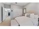 Cozy bedroom with soft lighting, a comfortable bed, neutral tones, and access to the laundry room at 2633 N Dundee St, Tampa, FL 33629