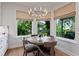 Dining area features a stylish chandelier and large windows with tropical views at 2633 N Dundee St, Tampa, FL 33629