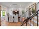 Dining room with hardwood floors and staircase featuring modern light fixture and natural light at 2633 N Dundee St, Tampa, FL 33629