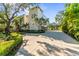 Stately home exterior with a long driveway, lush landscaping, and a well-maintained lawn at 2633 N Dundee St, Tampa, FL 33629