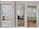 Hallway view showing a full length mirror and a peek into the bedroom suite and bathroom at 2633 N Dundee St, Tampa, FL 33629