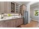 Elegant kitchen with custom cabinetry, a wine rack, and marble countertops for a sophisticated look at 2633 N Dundee St, Tampa, FL 33629