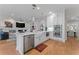 Spacious open-concept kitchen with a marble island, stainless steel appliances, and hardwood floors at 2633 N Dundee St, Tampa, FL 33629