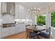 Bright kitchen with stainless steel appliances, a marble backsplash, and a cozy breakfast nook by the window at 2633 N Dundee St, Tampa, FL 33629