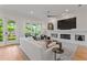 Bright living room with modern fireplace, hardwood floors, comfortable seating and access to outdoor space at 2633 N Dundee St, Tampa, FL 33629