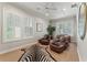 Bright living room featuring armchairs, plush zebra rug, and white shutters, perfect for a cozy and stylish home at 2633 N Dundee St, Tampa, FL 33629