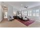 Well-lit main bedroom with a four poster bed, sitting area, and large windows with plantation shutters at 2633 N Dundee St, Tampa, FL 33629