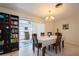 Bright dining area featuring a chandelier, neutral colors, and a view of sunroom at 2652 Forest S Pkwy, Largo, FL 33771