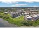 Stunning aerial view of the condominium complex surrounded by lush greenery near the water at 2700 Bayshore Blvd # 9404, Dunedin, FL 34698