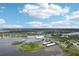 An aerial view shows a marina, surrounding waters, and the community's proximity to waterfront activities at 2700 Bayshore Blvd # 9404, Dunedin, FL 34698
