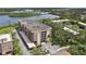 Aerial view of a well-maintained condominium complex with lush landscaping and convenient parking, situated near a scenic river at 2700 Bayshore Blvd # 9404, Dunedin, FL 34698