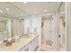 Bright bathroom with a long countertop, ample storage, and access to a separate toilet and shower area at 2700 Bayshore Blvd # 9404, Dunedin, FL 34698