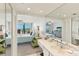 Large mirror in the bathroom reflects a comfortable bedroom with balcony access at 2700 Bayshore Blvd # 9404, Dunedin, FL 34698