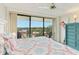 Bright bedroom features a ceiling fan, access to the balcony, and a colorful dresser at 2700 Bayshore Blvd # 9404, Dunedin, FL 34698