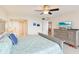 Inviting bedroom with a ceiling fan, TV, and a glimpse into the en-suite bathroom at 2700 Bayshore Blvd # 9404, Dunedin, FL 34698